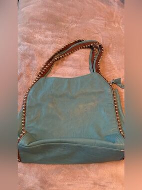 Big Buddha Grayson hobo bag features teal faux leather highlighted by polished